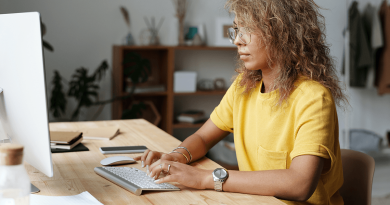 A person sitting comfortably at a computer while displaying proper posture