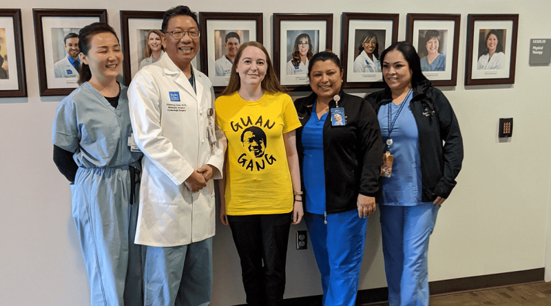 Alison Landolt stands with Dr. Guan and his team.