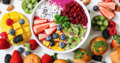 A colorful collection of fruits, chopped and displayed on a table.