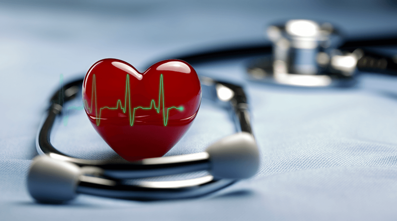 A model valentine-style heart sitting next to a stethoscope.